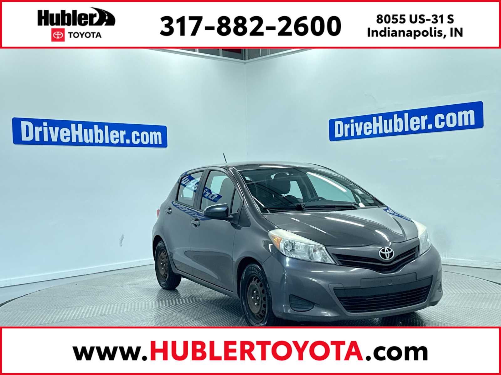 2014 Toyota Yaris L in Magnetic Gray Metallic — front three-quarter view